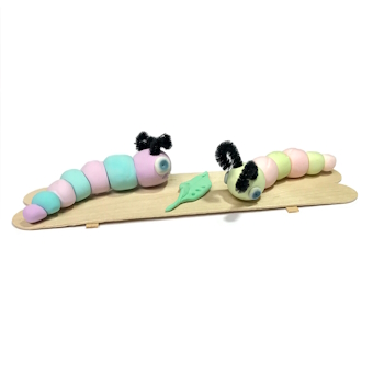 Sculpture of Two Caterpillars on a Wooden Plank with a Left in the Middle